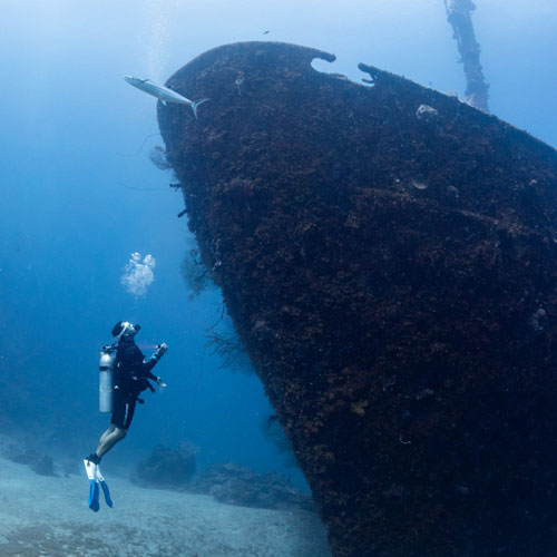 Diver underwater exploring a ship wreck