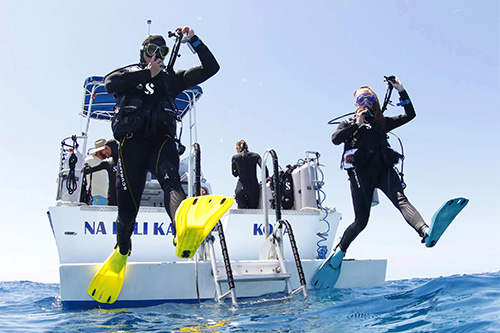 Scuba divers jumping off the boat in GO Sport Fins