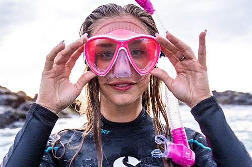 Snorkeler adjusting mask